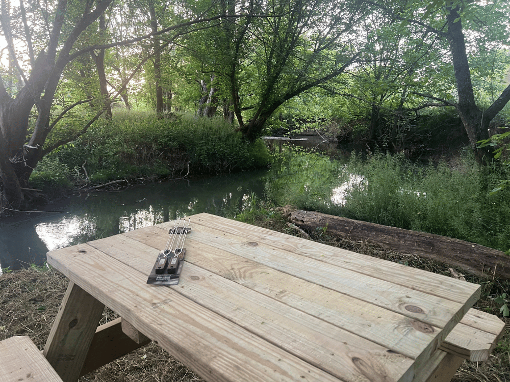Picnic table for 4 at Otter Beach Treehouse creekside picnic table and treehouse greeneville tn